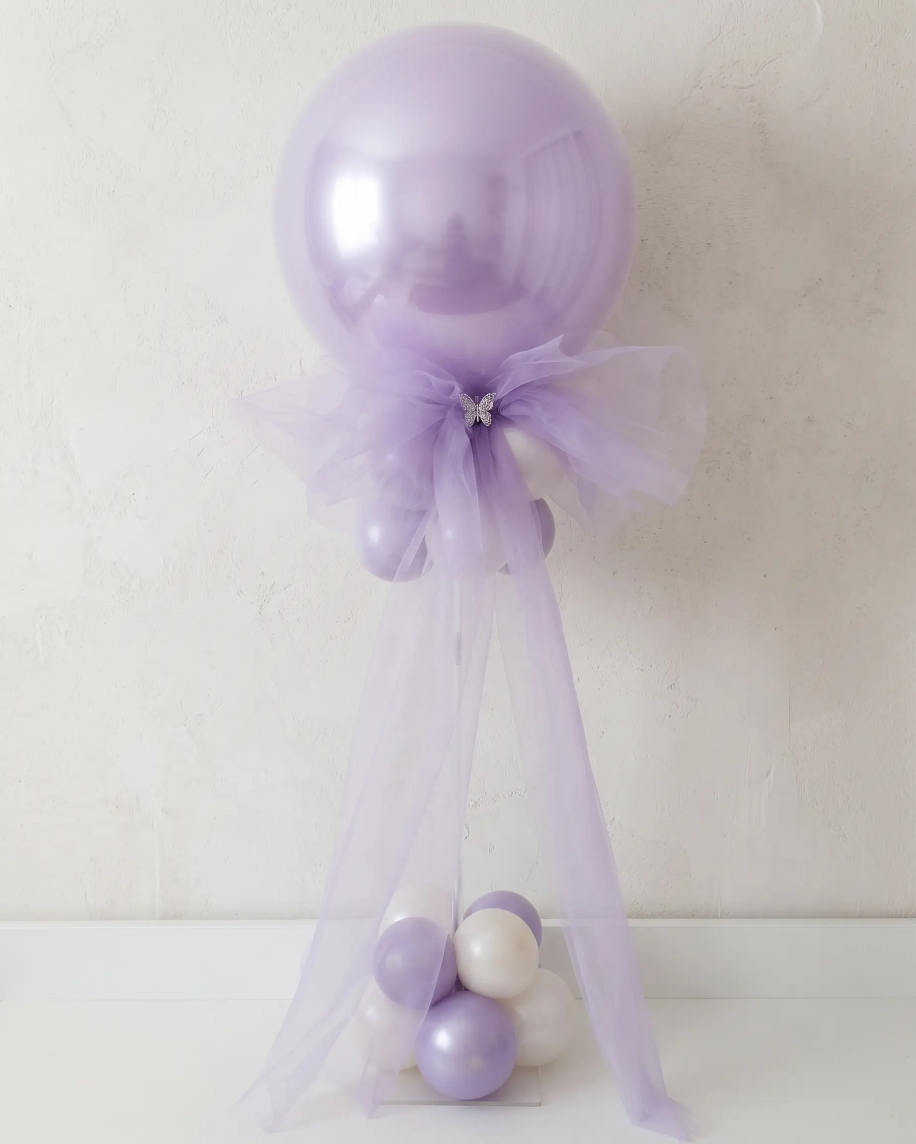 Buket od bijelih lateks balona s crnim mašnicama i velikim prozirnim balonom na vrhu, elegantna dekoracija za vjenčanja i moderne proslave, Joli Spot Zagreb.